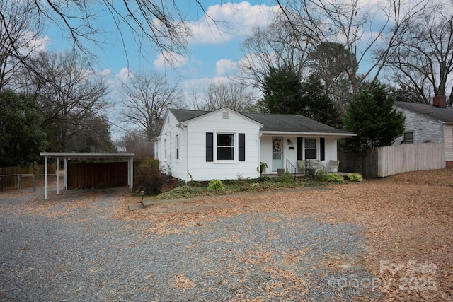 view of front of property with a porch and a carport