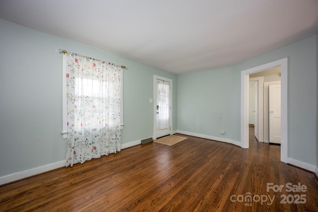 empty room with dark hardwood / wood-style floors