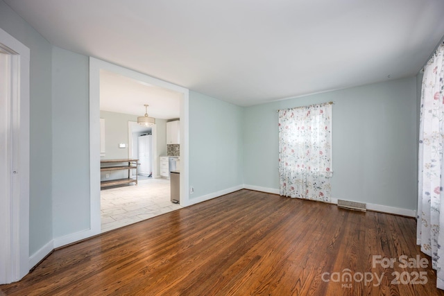 spare room featuring light hardwood / wood-style flooring