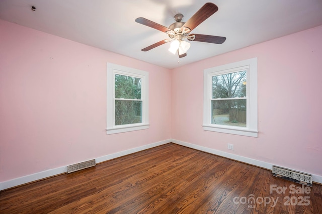 unfurnished room with ceiling fan and dark wood-type flooring