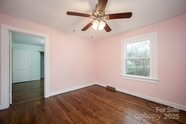 empty room featuring dark hardwood / wood-style floors and ceiling fan