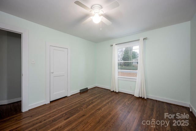 unfurnished room featuring ceiling fan and dark wood-type flooring