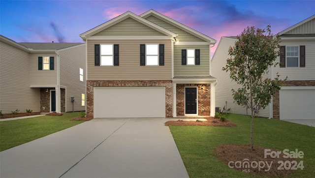 view of front facade featuring a yard and a garage