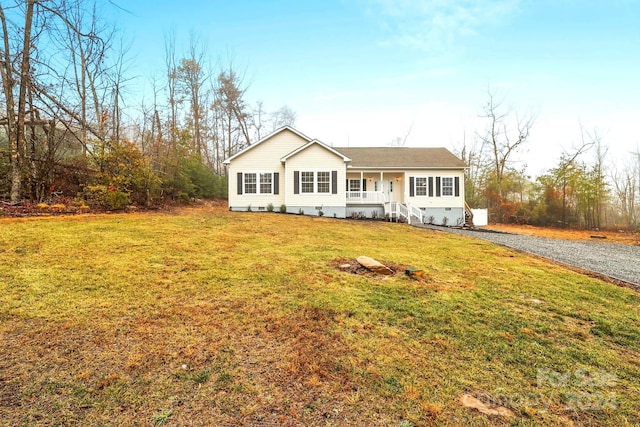 ranch-style house with a porch and a front lawn