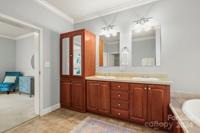 bathroom with a bathing tub, tile patterned flooring, crown molding, a textured ceiling, and vanity