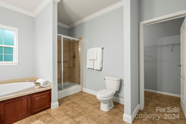 bathroom with tile patterned floors, toilet, ornamental molding, and shower with separate bathtub