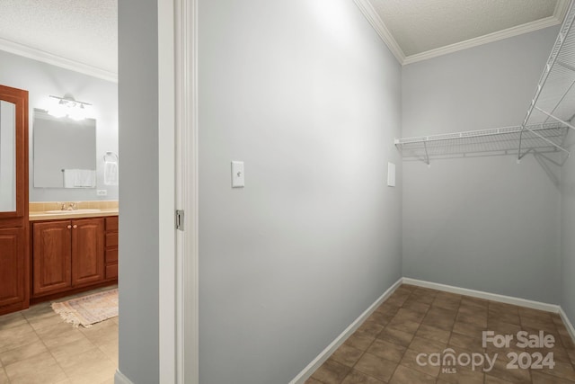 walk in closet featuring light tile patterned floors and sink