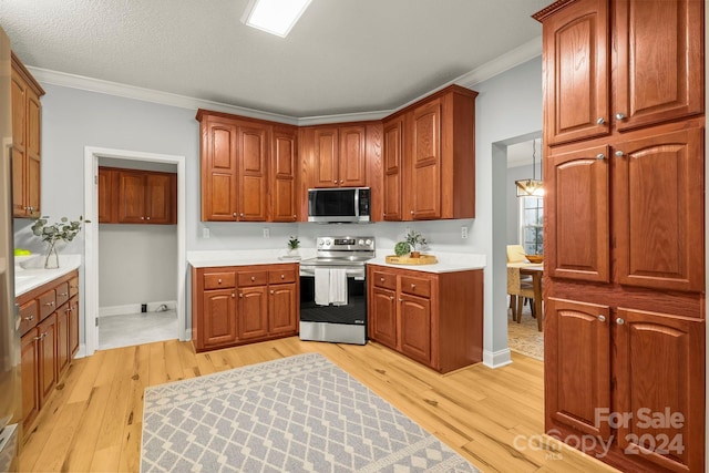 kitchen featuring light hardwood / wood-style floors, crown molding, and appliances with stainless steel finishes