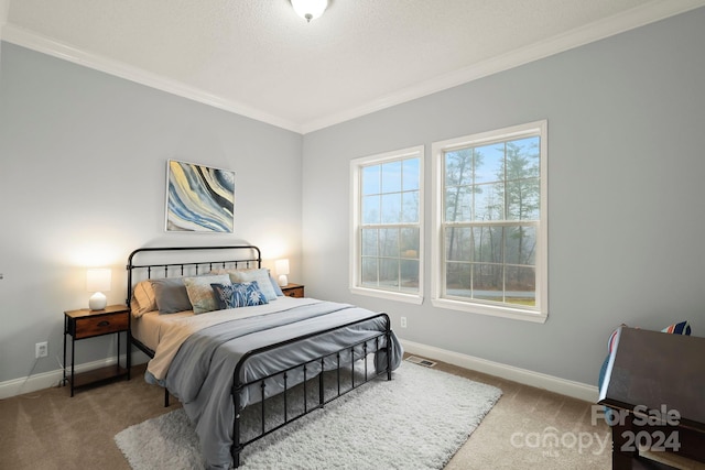 bedroom featuring carpet, a textured ceiling, and crown molding