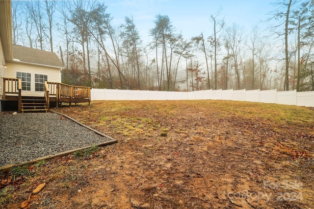 view of yard featuring a wooden deck