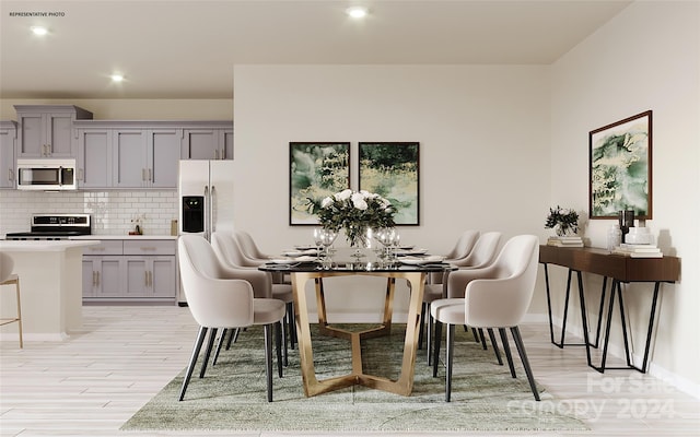 dining space with light hardwood / wood-style floors