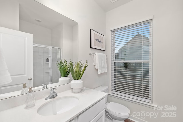 bathroom with vanity, toilet, and walk in shower