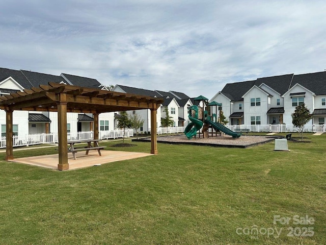 view of play area featuring a yard, a pergola, and a patio