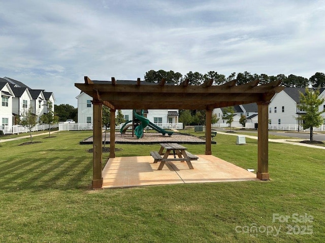 view of community featuring a playground and a lawn