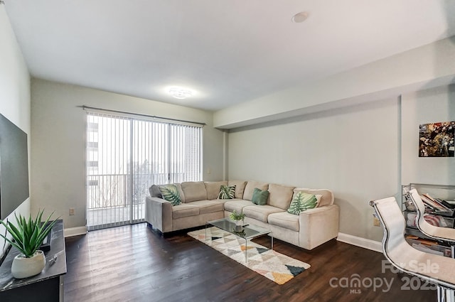 living room featuring baseboards and wood finished floors