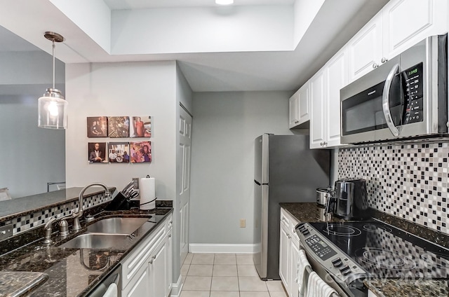 kitchen featuring white cabinetry, appliances with stainless steel finishes, tasteful backsplash, and a sink