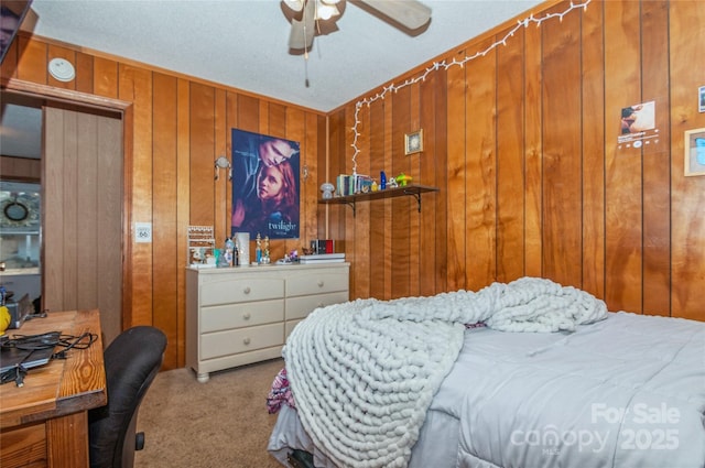 carpeted bedroom featuring ceiling fan and wooden walls