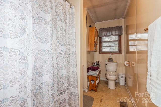 bathroom with walk in shower, toilet, and ornamental molding