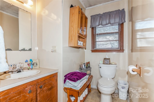 bathroom featuring toilet, vanity, tile patterned floors, and ornamental molding