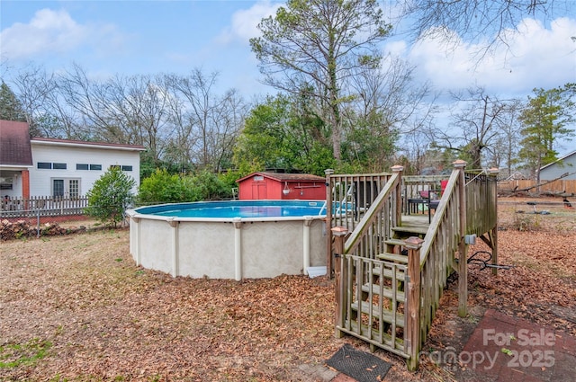 view of yard featuring a fenced in pool and a shed