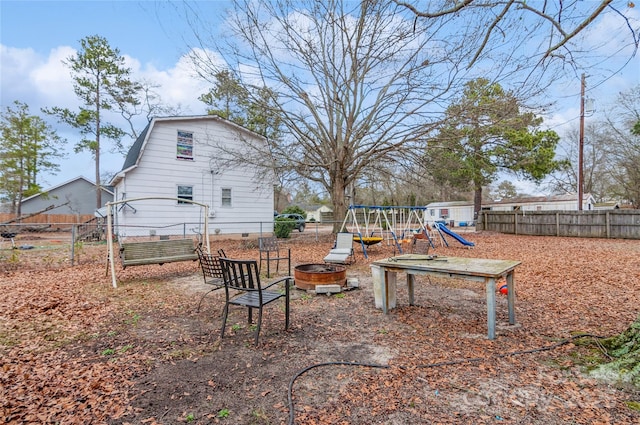 view of yard with a playground and an outdoor fire pit