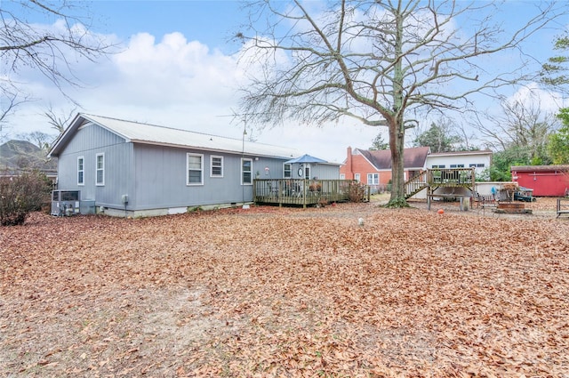 rear view of property featuring a wooden deck