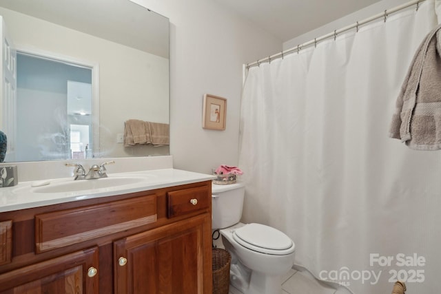 full bathroom with toilet, vanity, and tile patterned floors