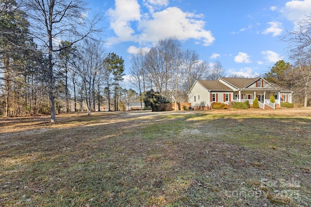 view of front of home with a porch and a front yard