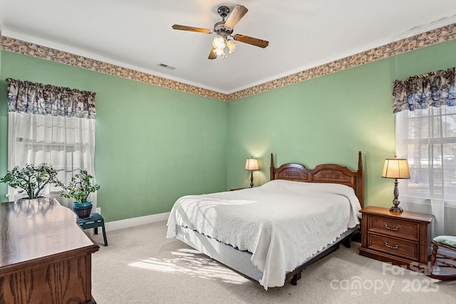 bedroom with ceiling fan, light colored carpet, and crown molding