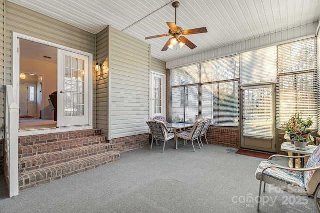 sunroom with ceiling fan and wood ceiling