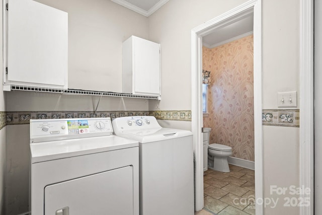 clothes washing area featuring cabinets, separate washer and dryer, and crown molding