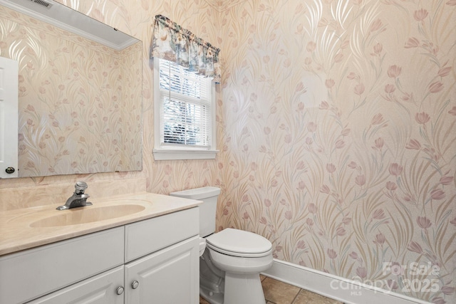 bathroom featuring tile patterned floors, vanity, ornamental molding, and toilet