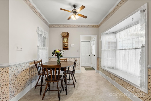 dining room with ceiling fan and crown molding