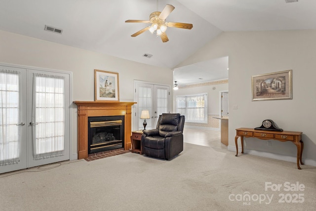 carpeted living room with french doors, ceiling fan, and lofted ceiling