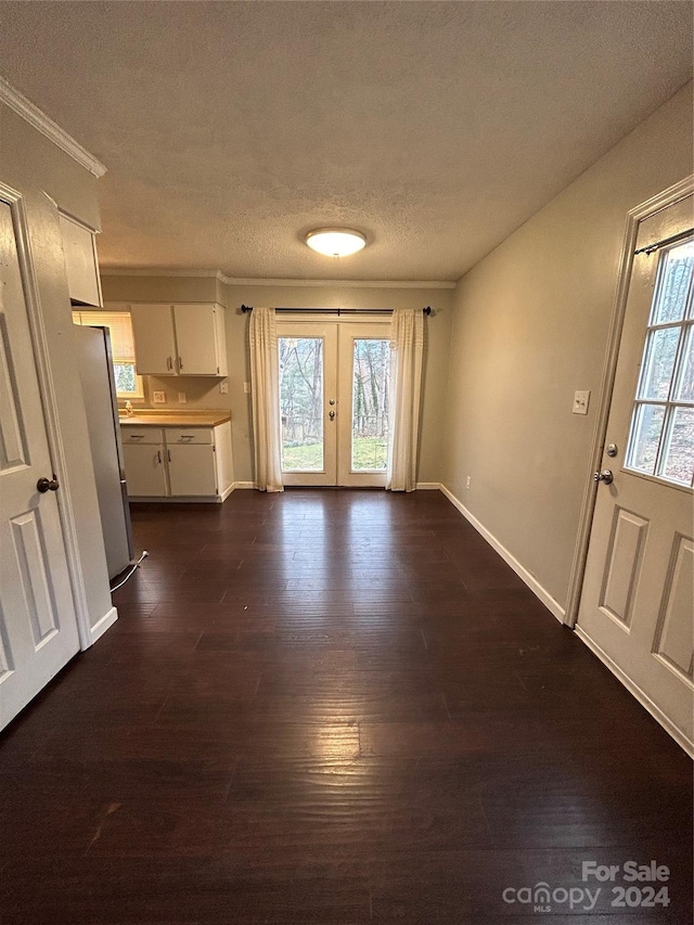 interior space with french doors, a textured ceiling, and dark hardwood / wood-style flooring