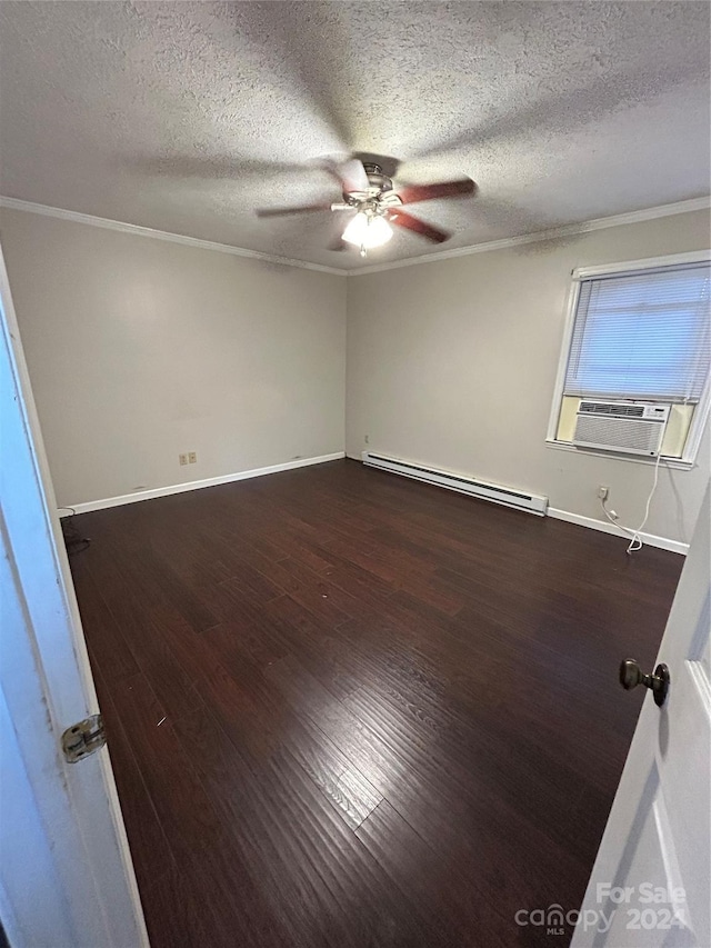 empty room with a textured ceiling, cooling unit, dark hardwood / wood-style floors, and a baseboard heating unit