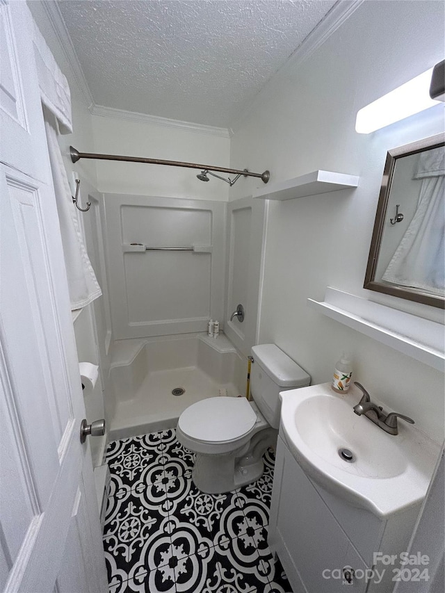 bathroom featuring toilet, a shower, crown molding, and a textured ceiling