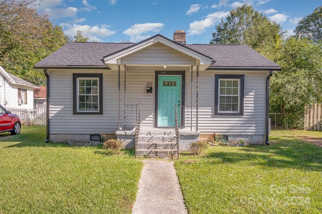 bungalow-style house featuring a front lawn