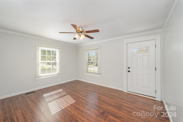 foyer entrance with ceiling fan, dark hardwood / wood-style flooring, crown molding, and a wealth of natural light