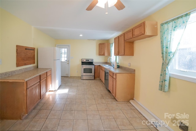 kitchen with ceiling fan, sink, light tile patterned floors, and stainless steel appliances