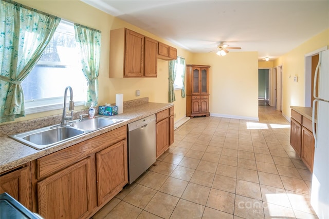 kitchen with ceiling fan, dishwasher, sink, white refrigerator, and light tile patterned floors