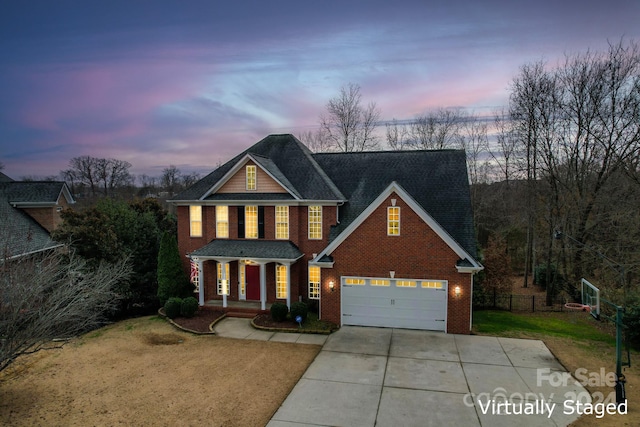 view of front of home featuring a porch, a garage, and a lawn