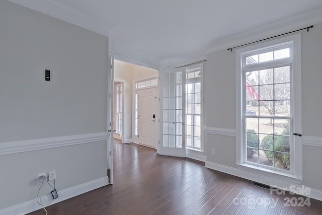 doorway to outside featuring crown molding, dark hardwood / wood-style flooring, and a healthy amount of sunlight