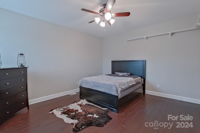 bedroom featuring ceiling fan and dark hardwood / wood-style floors