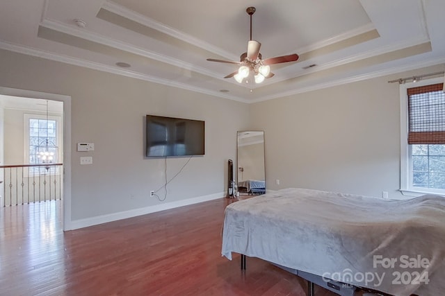 bedroom featuring ceiling fan, a raised ceiling, and crown molding