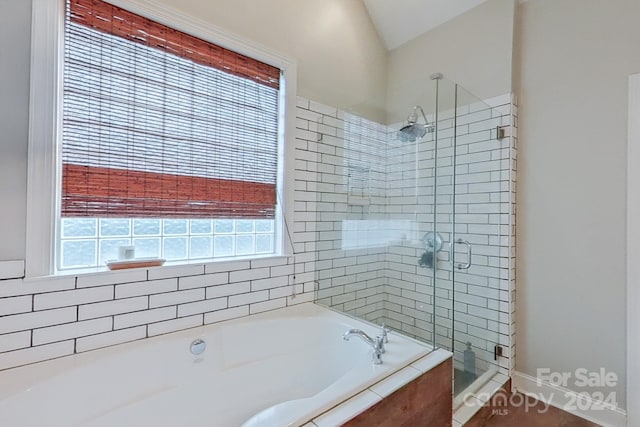 bathroom featuring separate shower and tub