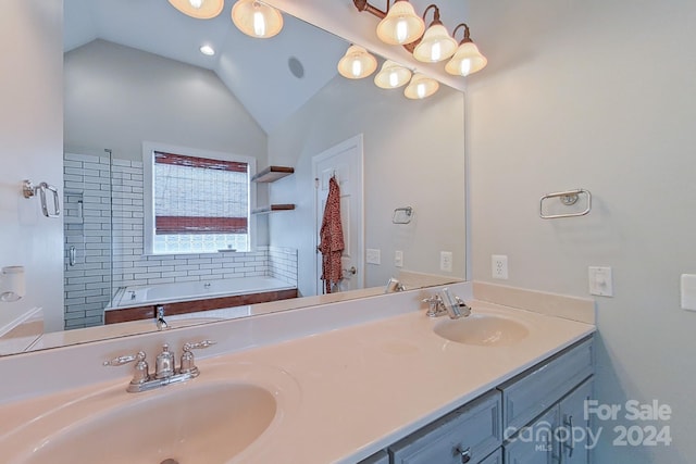 bathroom featuring vanity, lofted ceiling, and a bathing tub