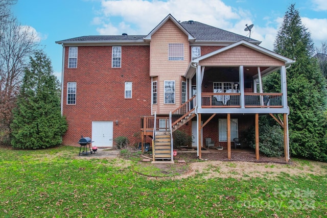 rear view of property with a yard and a deck