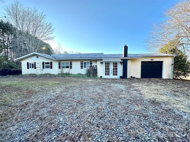 single story home with a garage and french doors