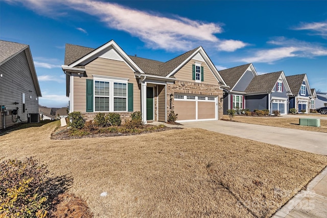 craftsman-style house featuring cooling unit, a front lawn, and a garage